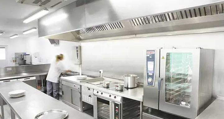 Necessary materials and equipment for opening a bakery, employee preparing in the kitchen